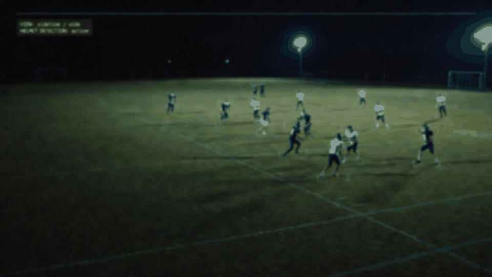 Background film plate — sideline night telemetry (mood only)